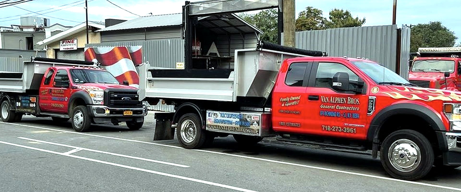 Red Van Alphen Bros. dump trucks parked on a street